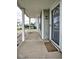 Covered porch with white columns, sidelight window, and a view of the neighborhood at 11303 Cuyahoga Dr, Indianapolis, IN 46235