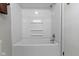 This bathroom includes a standard bathtub and shower combination with white fixtures at 11461 N College Ave, Carmel, IN 46032