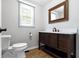 Cozy powder room features single sink vanity and a decorative mirror at 11461 N College Ave, Carmel, IN 46032