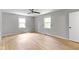 Bedroom features wood floors, two windows, a ceiling fan, and closet at 11461 N College Ave, Carmel, IN 46032