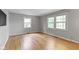 Spacious bedroom with hardwood floors, large windows, neutral paint, and ample natural light at 11461 N College Ave, Carmel, IN 46032