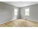 Bright bedroom features wood floors and two windows offering natural light at 11461 N College Ave, Carmel, IN 46032