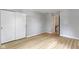 Bedroom with hardwood floors and a closet with sliding doors at 11461 N College Ave, Carmel, IN 46032
