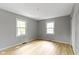The bedroom has wood floors and two windows offering ample natural light at 11461 N College Ave, Carmel, IN 46032