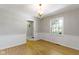 Dining room featuring hardwood floors, white wainscoting, a chandelier and natural light from a window at 11461 N College Ave, Carmel, IN 46032