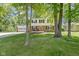 Charming two-story home featuring a brick facade, symmetrical windows, and well-maintained landscaping in a leafy setting at 11461 N College Ave, Carmel, IN 46032
