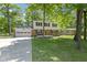 Charming two-story home featuring a brick facade, attached garage and a lush, tree-filled front yard at 11461 N College Ave, Carmel, IN 46032