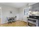 Eat-in kitchen featuring stainless appliances and access to backyard at 11461 N College Ave, Carmel, IN 46032