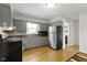 Bright kitchen featuring stainless appliances, gray cabinets, and natural light at 11461 N College Ave, Carmel, IN 46032