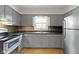 Cozy kitchen featuring gray cabinets and stainless steel appliances at 11461 N College Ave, Carmel, IN 46032