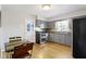 Traditional eat-in kitchen featuring wood floors and stainless steel appliances at 11461 N College Ave, Carmel, IN 46032