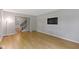 Open living room features hardwood floors, a TV on the wall, neutral paint, and staircase to the next level at 11461 N College Ave, Carmel, IN 46032
