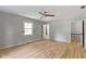 Main bedroom with wood floors, window and door leading to an ensuite bathroom at 11461 N College Ave, Carmel, IN 46032