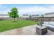 Expansive backyard featuring a well-manicured lawn, patio, and mature tree, perfect for outdoor gatherings at 11521 Short Iron Ln, Indianapolis, IN 46235