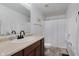 Bright bathroom featuring a vanity with a sink, toilet and a shower with a white curtain and minimalist decor at 11521 Short Iron Ln, Indianapolis, IN 46235