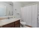 Well-lit bathroom equipped with a dark vanity, shower-tub combo, and white towels, offering a refreshing and functional space at 11521 Short Iron Ln, Indianapolis, IN 46235
