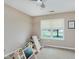 Bright bedroom features a ceiling fan, carpet flooring, and a sunlit window, perfect for a playroom at 11521 Short Iron Ln, Indianapolis, IN 46235
