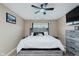 Bright bedroom showcases a large window, ceiling fan and a gray wood bedframe with matching bedside tables at 11521 Short Iron Ln, Indianapolis, IN 46235