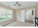 Bedroom features large window, neutral walls, carpet flooring, and closet, creating a cozy atmosphere at 11521 Short Iron Ln, Indianapolis, IN 46235