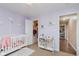 This baby bedroom showcases a closet, crib and modern decor, creating a comfortable and inviting atmosphere at 11521 Short Iron Ln, Indianapolis, IN 46235