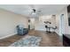 Open-concept living room features hardwood floors, modern ceiling fan and furniture creating a cozy and inviting atmosphere at 11521 Short Iron Ln, Indianapolis, IN 46235