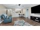 Cozy living room with hard surface floors, large TV, a ceiling fan, and lots of natural light at 11521 Short Iron Ln, Indianapolis, IN 46235