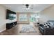 Comfortable living room features hard surface floors, ceiling fan and a sliding glass door to backyard at 11521 Short Iron Ln, Indianapolis, IN 46235