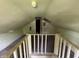 View of the attic from the top of the stairs, which offers potential for storage or future living space at 1201 N Canal St, Alexandria, IN 46001