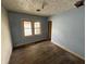 Bedroom with blue walls, hardwood floors, window, and ceiling light at 1201 N Canal St, Alexandria, IN 46001