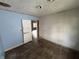 Bedroom featuring unfinished drywall, door, and wood floor at 1201 N Canal St, Alexandria, IN 46001