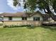 Attractive home with light yellow siding, a brick foundation, and lush yard at 1201 N Canal St, Alexandria, IN 46001
