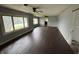 Empty living room with hardwood floors, ceiling fans, and lots of natural light at 1201 N Canal St, Alexandria, IN 46001