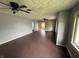 A vacant living room with hardwood floors, ceiling fans, and bright windows at 1201 N Canal St, Alexandria, IN 46001