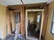Framing for walls in a room being remodeled, with a view to an adjacent room with a window at 1201 N Canal St, Alexandria, IN 46001