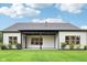 Stunning backyard featuring lush green grass, a covered patio, and white siding at 12594 Pasco St, Fishers, IN 46038