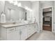 Clean and bright bathroom with double sinks, modern fixtures, and a walk-in closet at 12594 Pasco St, Fishers, IN 46038