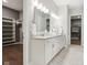 Bright bathroom with double sinks, white cabinetry, and access to a walk-in closet at 12594 Pasco St, Fishers, IN 46038