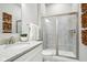 Bathroom featuring a glass enclosed shower, granite vanity top, and tiled floors at 12594 Pasco St, Fishers, IN 46038