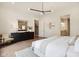 Spacious bedroom showcasing hardwood floors, a dresser, and view to an ensuite bathroom at 12594 Pasco St, Fishers, IN 46038
