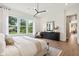 Bright bedroom featuring large windows offering outdoor views and modern furnishings at 12594 Pasco St, Fishers, IN 46038