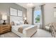 Bedroom boasts a cozy ambiance with neutral tones, soft lighting, and a large window for natural light at 12594 Pasco St, Fishers, IN 46038