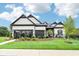 Charming two-story home with manicured landscaping and black trim accents at 12594 Pasco St, Fishers, IN 46038
