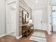 Welcoming foyer boasts elegant wainscoting, hardwood floors, and a stylish console table at 12594 Pasco St, Fishers, IN 46038