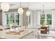 Open kitchen with island seating, stainless faucet, and natural light connects to living and dining areas at 12594 Pasco St, Fishers, IN 46038