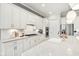 Beautiful kitchen boasts white cabinetry, stainless steel appliances, and sleek countertops at 12594 Pasco St, Fishers, IN 46038