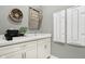 Convenient laundry room with white cabinets, sink, and drying rack for efficient laundry care at 12594 Pasco St, Fishers, IN 46038