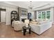 Comfortable living room features a fireplace, built-in cabinets, and large windows at 12594 Pasco St, Fishers, IN 46038