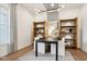 The office features hardwood flooring, recessed lighting, modern chandelier, and a large window at 12594 Pasco St, Fishers, IN 46038