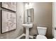 Stylish powder room featuring modern fixtures, neutral tones, and a pedestal sink at 12594 Pasco St, Fishers, IN 46038