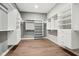 Spacious walk-in closet boasts custom shelving, drawers, and hardwood flooring at 12594 Pasco St, Fishers, IN 46038